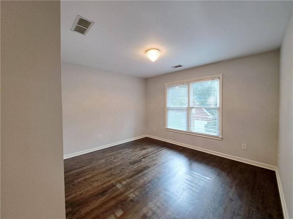 2242 Lenox Walk Northeast Atlanta, GA 30319 - Photo 29 of 80 an empty room with wooden floor and windows