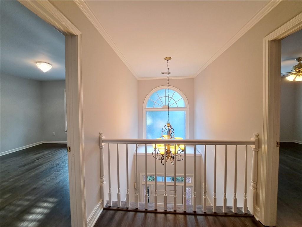 2242 Lenox Walk Northeast Atlanta, GA 30319 - Photo 32 of 80 a view of a hallway with wooden floor and chandelier