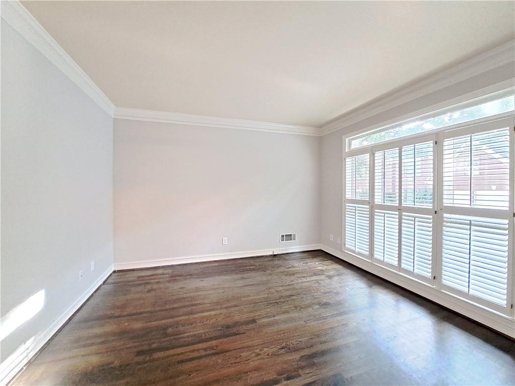 2242 Lenox Walk Northeast Atlanta, GA 30319 - Photo 4 of 80 a view of an empty room with wooden floor and a window