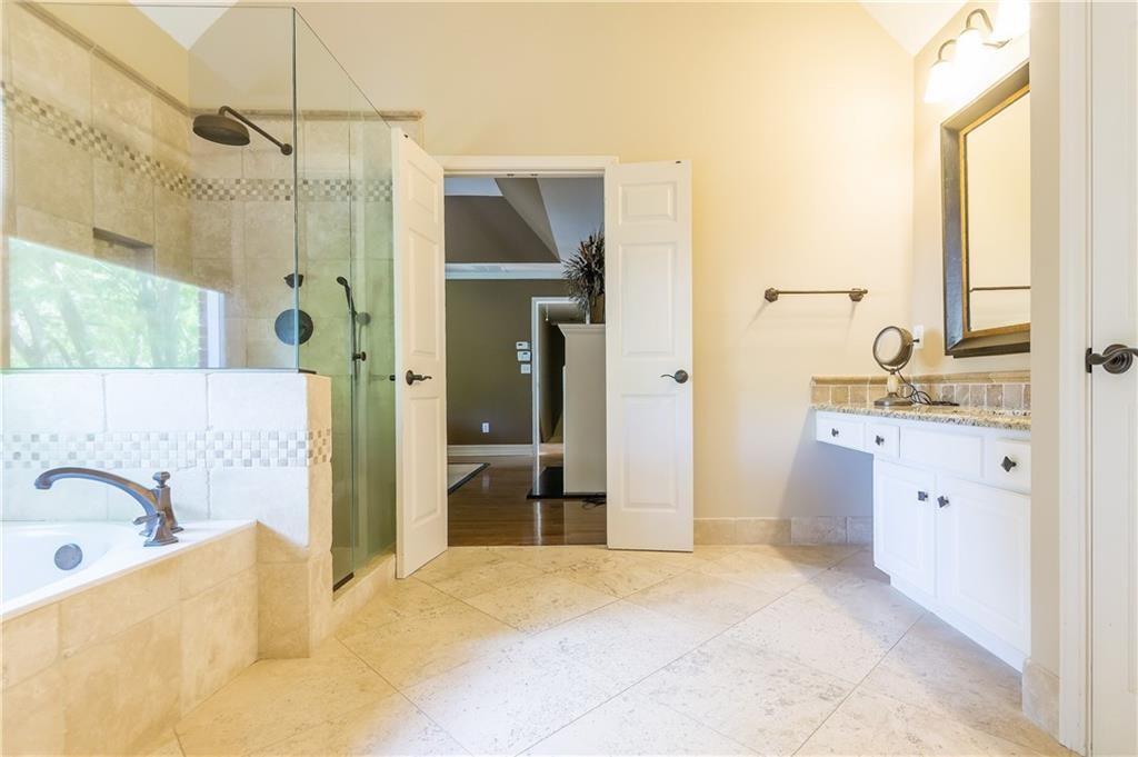 2242 Lenox Walk Northeast Atlanta, GA 30319 - Photo 44 of 80 a bathroom with a tub sink and mirror