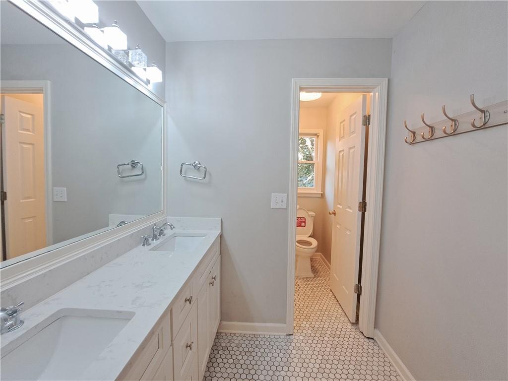 2242 Lenox Walk Northeast Atlanta, GA 30319 - Photo 50 of 80 a bathroom with a double vanity sink and a mirror