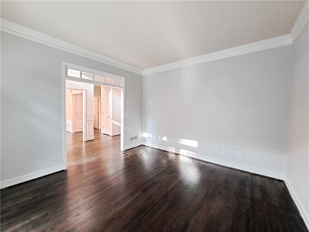 2242 Lenox Walk Northeast Atlanta, GA 30319 - Photo 5 of 80 a view of an empty room with wooden floor and a window
