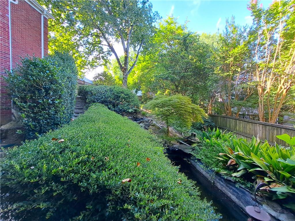 2242 Lenox Walk Northeast Atlanta, GA 30319 - Photo 75 of 80 a view of a garden with plants and large trees