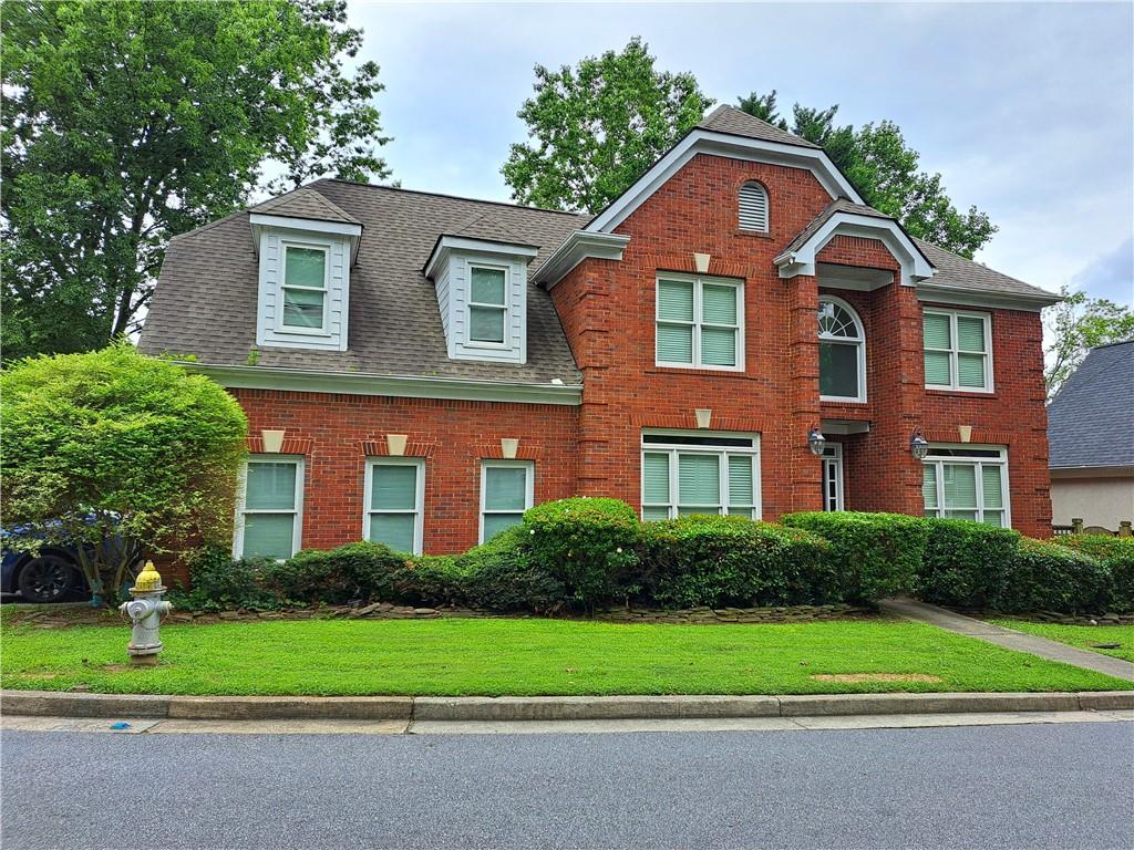 2242 Lenox Walk Northeast Atlanta, GA 30319 - Photo 77 of 80 a front view of a house with a yard and trees