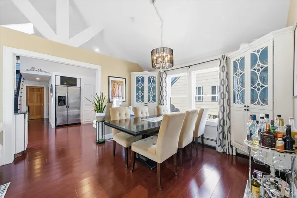 a view of a dining room with furniture wooden floor and chandelier