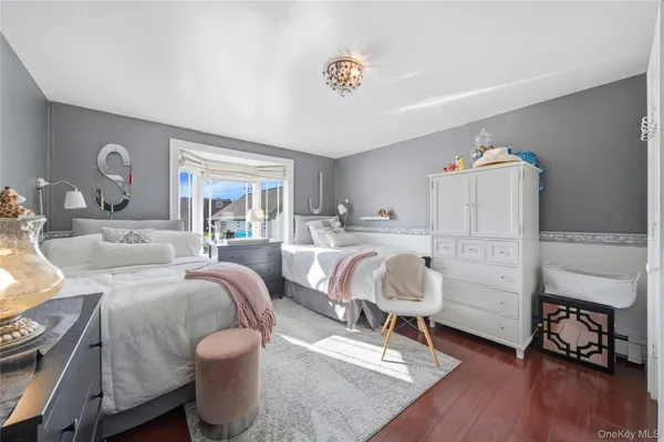 a bedroom with furniture and a wooden floor