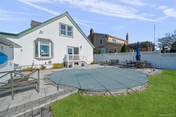 a view of a house with backyard and sitting area