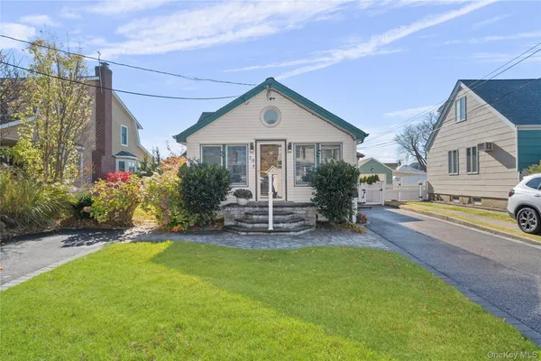 a front view of a house with yard and green space