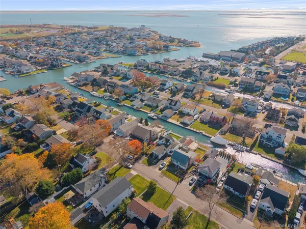 an aerial view of a houses with a lake
