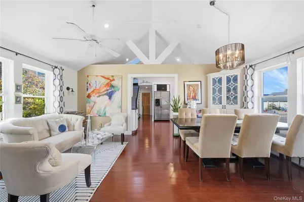 a view of a dining room with furniture wooden floor and chandelier