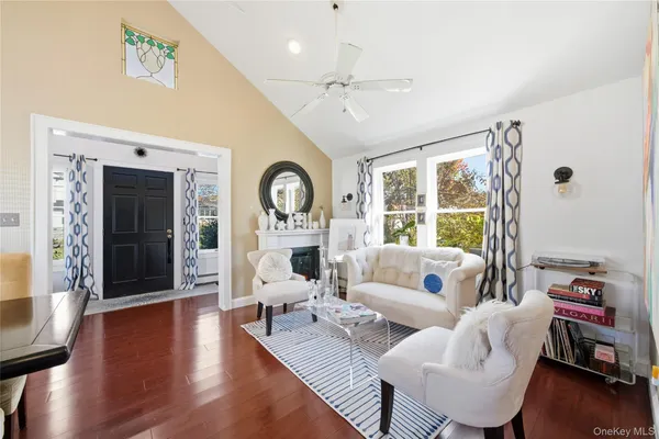a living room with fireplace furniture and a large window