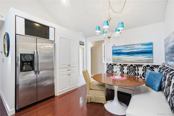 a kitchen with stainless steel appliances kitchen island granite countertop a refrigerator and a sink