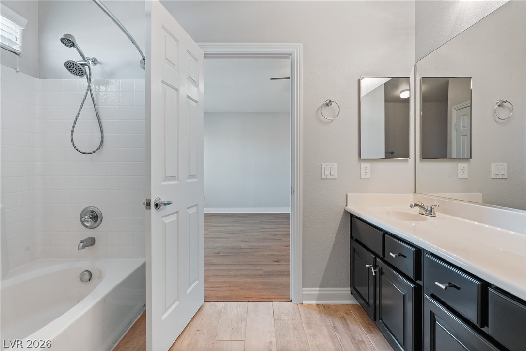 1328 Spice Ridge Court Henderson, NV 89012 - Photo 25 of 51 This clean and bright Primary bathroom features a vanity with ample counter space and a modern tub and shower combination.