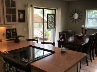 10907 Gable Street Boca Raton, FL 33428 - Photo 20 of 40 a kitchen with a table chairs and a refrigerator
