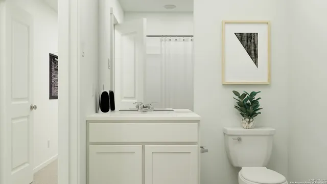 a bathroom with a toilet a sink and mirror