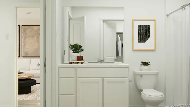a bathroom with a sink a toilet and mirror