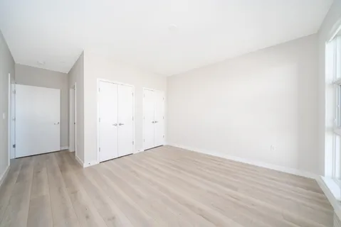 a view of an empty room and wooden floor