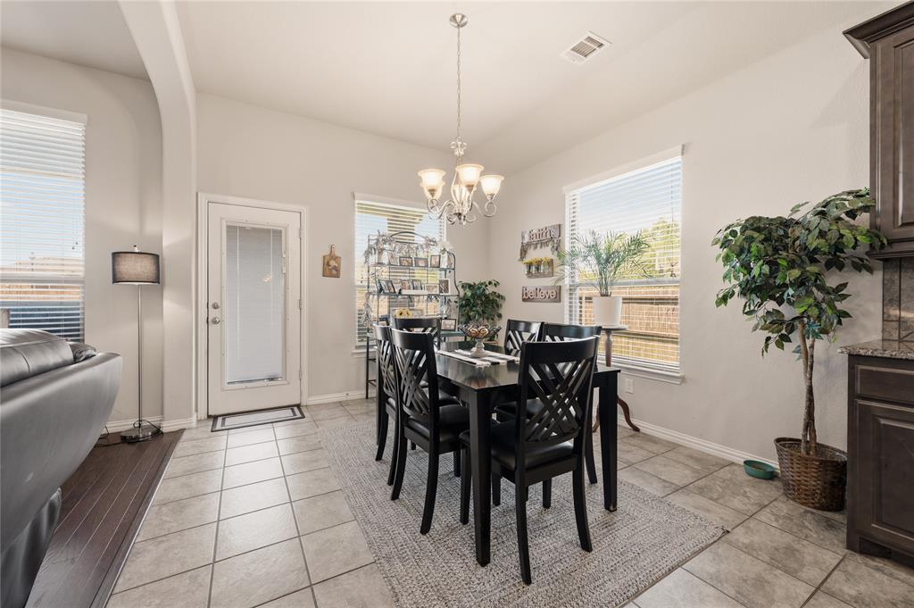 140 Chestnut Road Waxahachie, TX 75165 - Photo 15 of 26 Dining area featuring tile flooring, a multi-light chandelier, and multiple windows