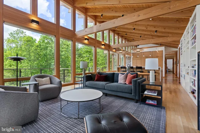 a view of a hallway with stairs and furniture