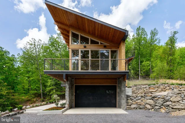 a porch with wooden floor and glass door