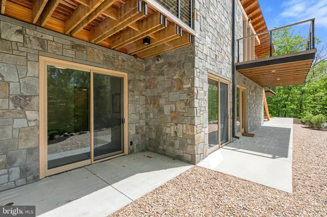 a view of balcony with floor to ceiling window and wooden floor
