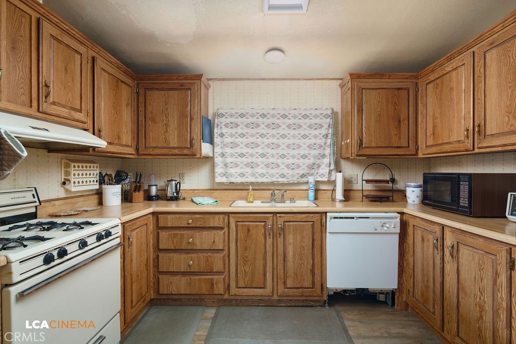 6004 Maple Avenue Mountain Mesa, CA 93240 - Photo 8 of 26 a kitchen with stainless steel appliances granite countertop a stove and a sink