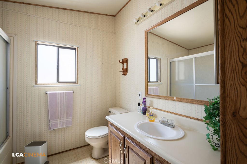 6004 Maple Avenue Mountain Mesa, CA 93240 - Photo 9 of 26 a bathroom with a sink toilet and mirror