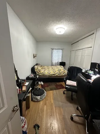 a bedroom with furniture and a wooden floor