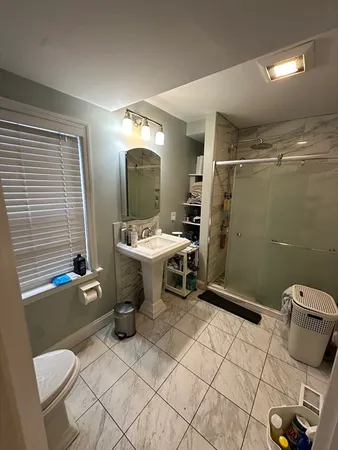 a bathroom with a sink toilet and shower
