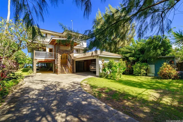 a view of a house with a yard and tree s