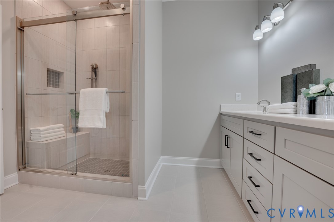 15305 Princess Lauren Lane Midlothian, VA 23112 - Photo 25 of 36 a bathroom with a shower sink and mirror