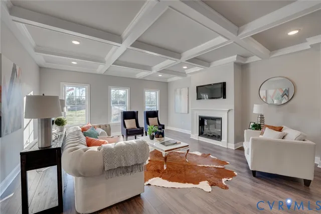 a living room with furniture a fireplace and a flat screen tv