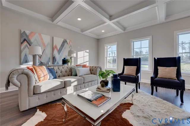 a living room with furniture a rug and a flat screen tv