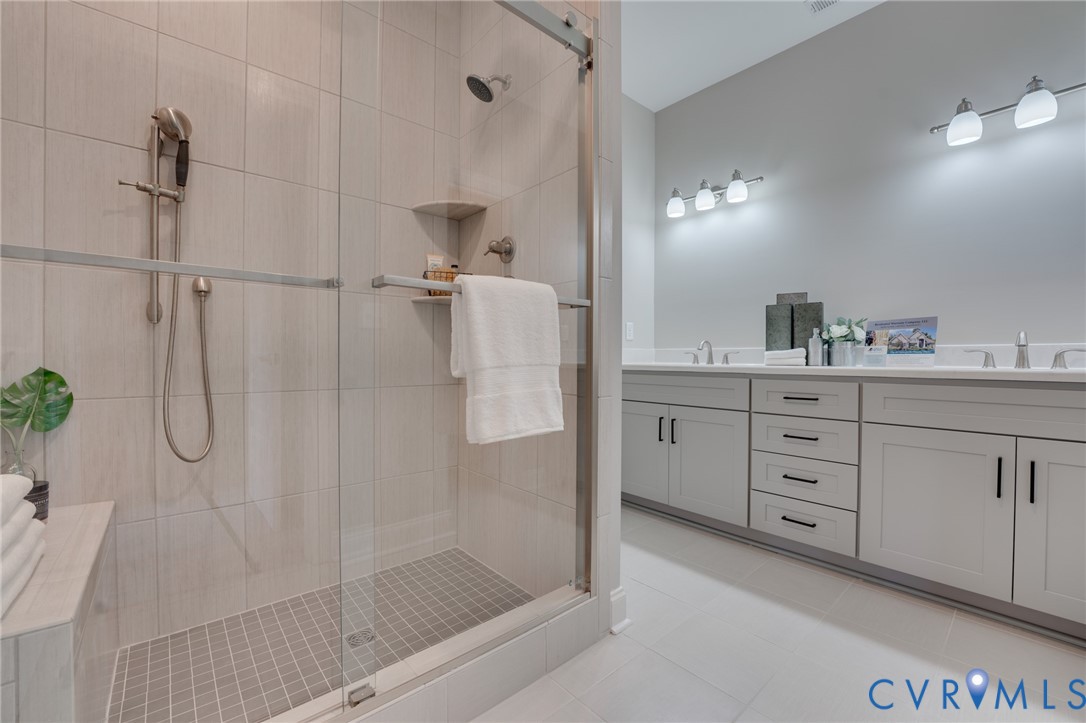 15305 Princess Lauren Lane Midlothian, VA 23112 - Photo 10 of 36 a bathroom with a double vanity sink a shower and a mirror