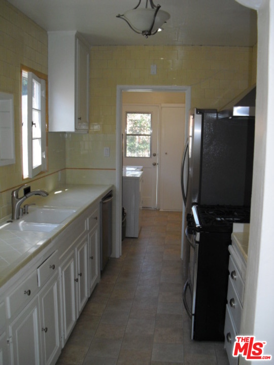 9963 Durant Drive Beverly Hills, CA 90212 - Photo 11 of 23 a bathroom with a granite countertop sink a toilet and mirror