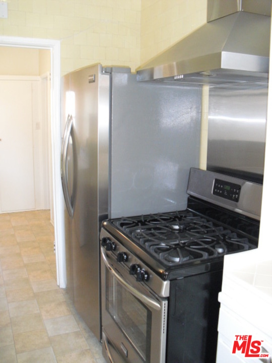 9963 Durant Drive Beverly Hills, CA 90212 - Photo 12 of 23 a kitchen with granite countertop a stove and a refrigerator