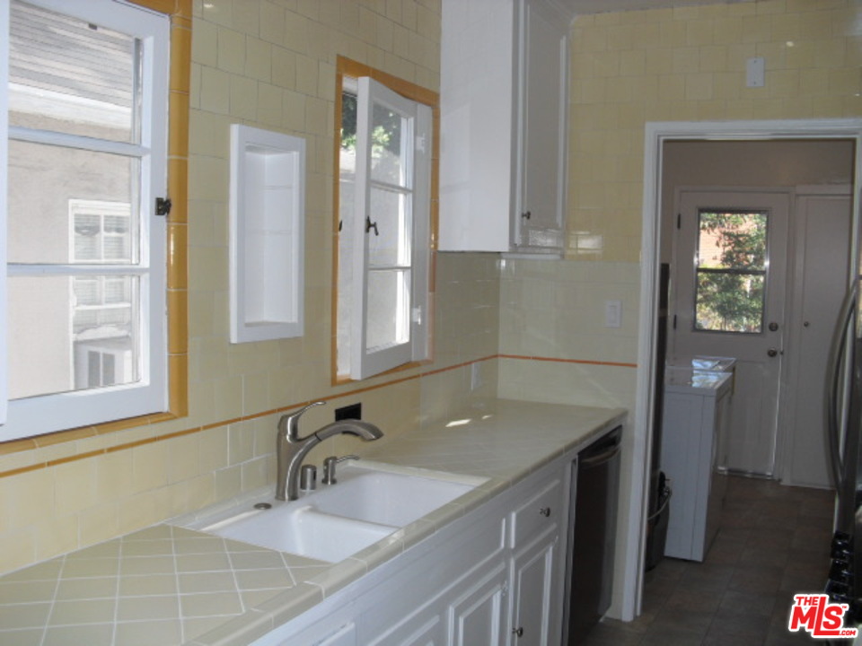9963 Durant Drive Beverly Hills, CA 90212 - Photo 13 of 23 a bathroom with a granite countertop sink and a mirror