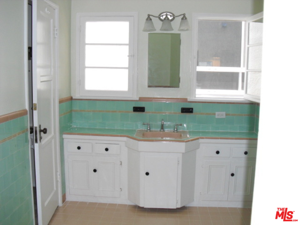 9963 Durant Drive Beverly Hills, CA 90212 - Photo 17 of 23 a bathroom with a granite countertop sink and a window