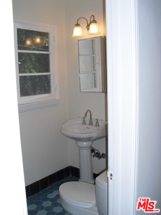 9963 Durant Drive Beverly Hills, CA 90212 - Photo 20 of 23 a bathroom with a toilet sink and mirror