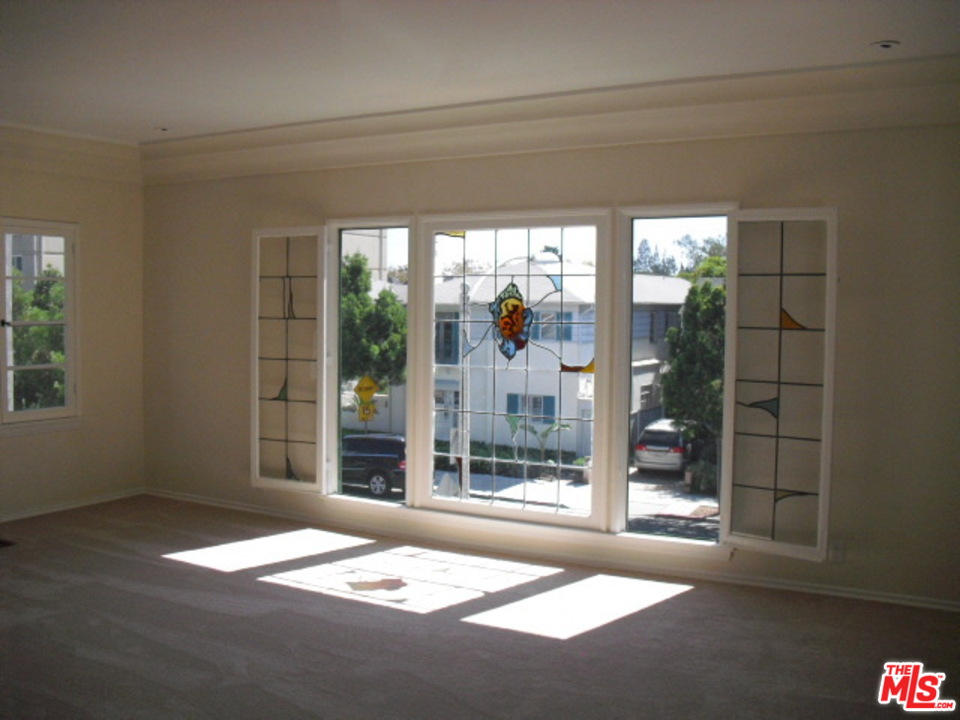 9963 Durant Drive Beverly Hills, CA 90212 - Photo 5 of 23 a living room with a large window and walk in closet
