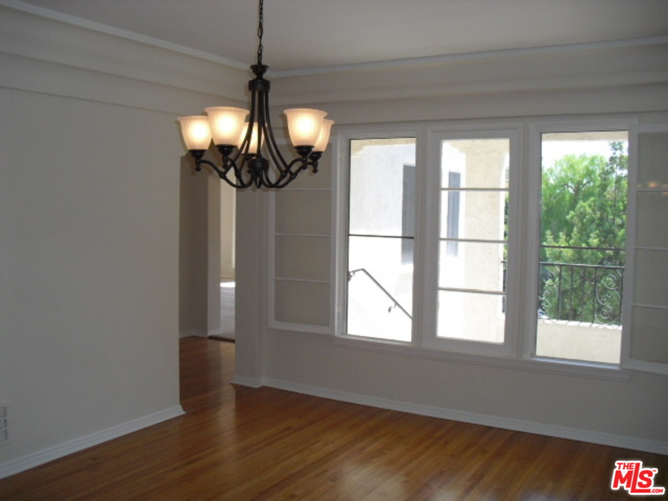 9963 Durant Drive Beverly Hills, CA 90212 - Photo 7 of 23 a view of empty room with wooden floor and fan