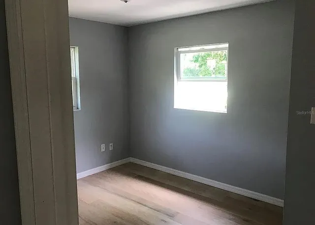 a view of an empty room and a window