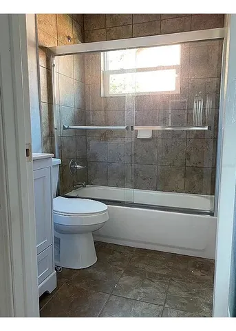 a bathroom with a toilet and a shower