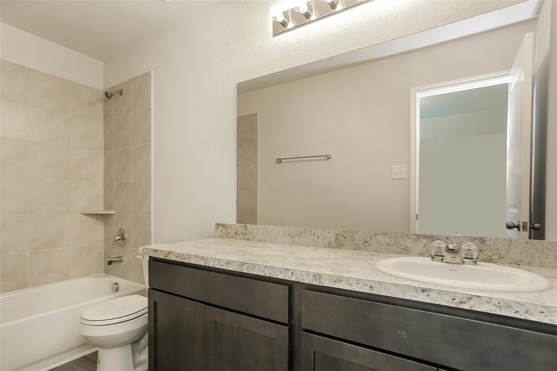 22382 Clear Castle Drive Porter, TX 77365 - Photo 13 of 14 a bathroom with a granite countertop sink toilet and shower