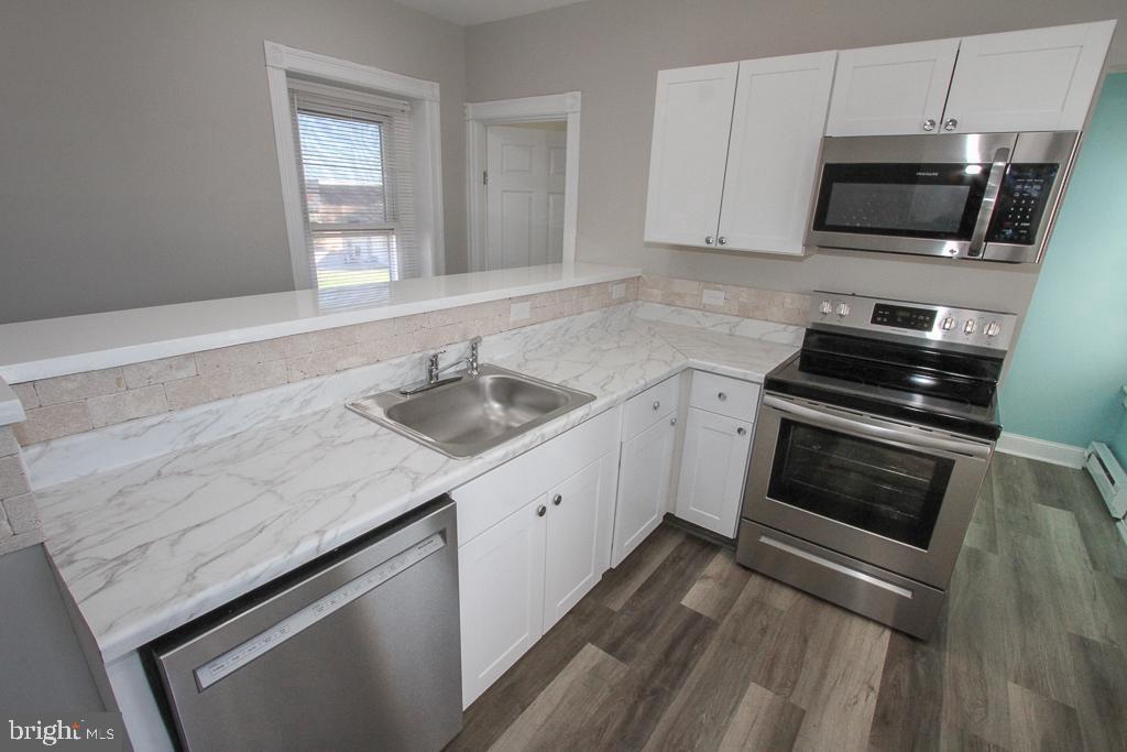 700 Main Street Red Hill, PA 18076 - Photo 1 of 14 a kitchen with a sink stove and microwave