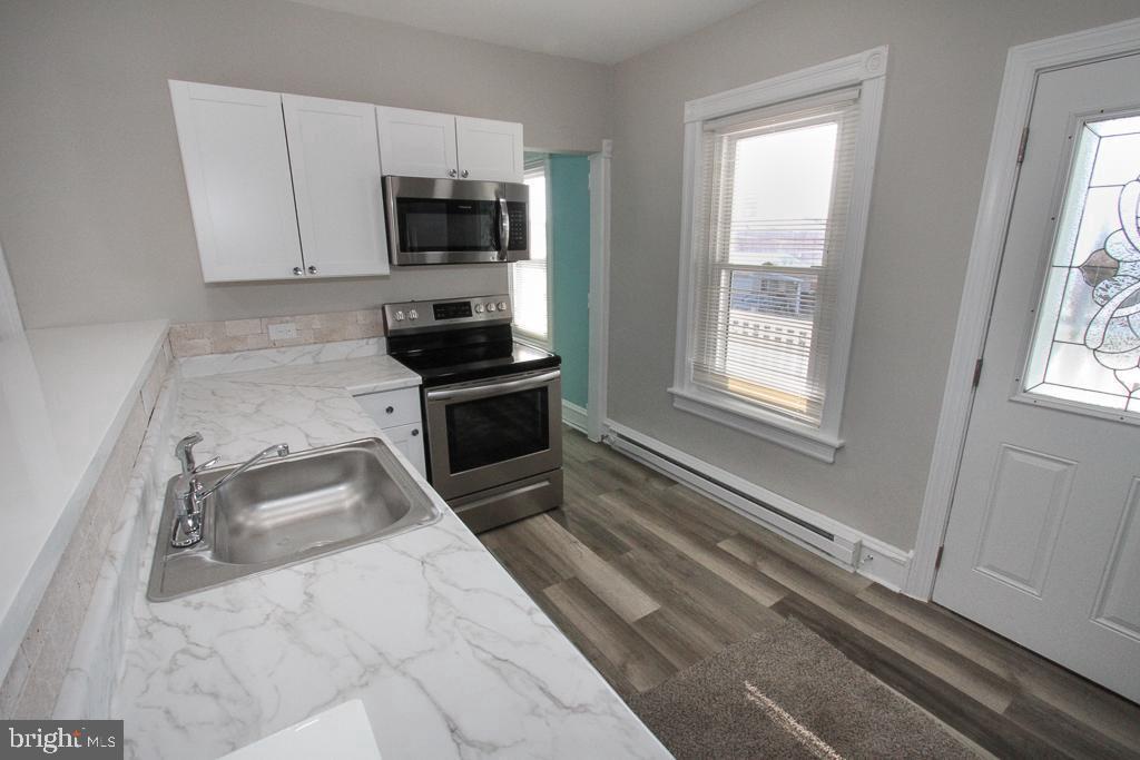 700 Main Street Red Hill, PA 18076 - Photo 2 of 14 a kitchen with a stove a microwave and a sink