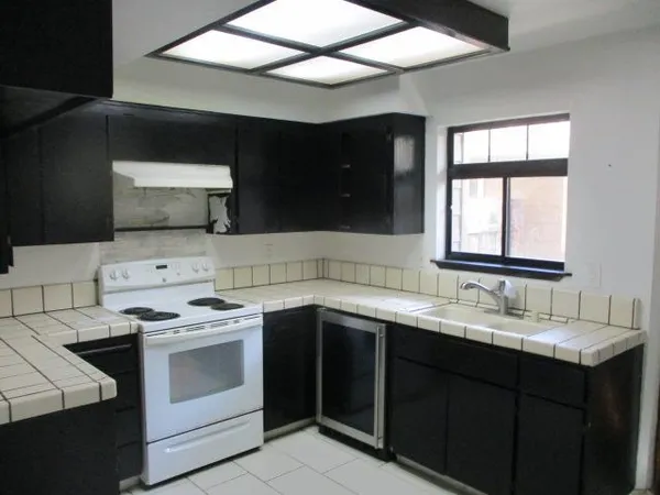 a kitchen with a sink stove and microwave
