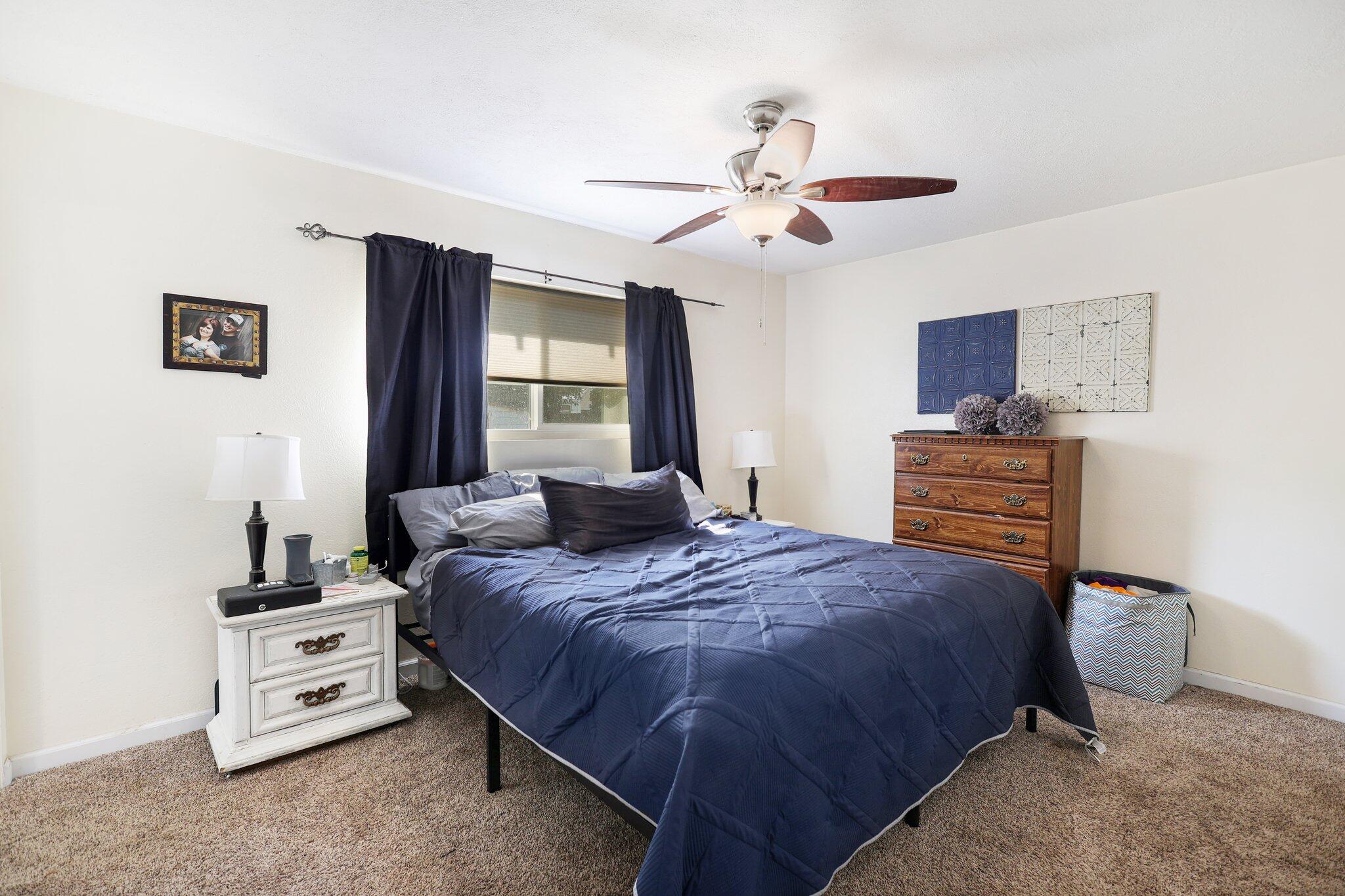 140 Chestnut Avenue Red Bluff, CA 96080 - Photo 11 of 26 a bedroom with a bed and a chandelier