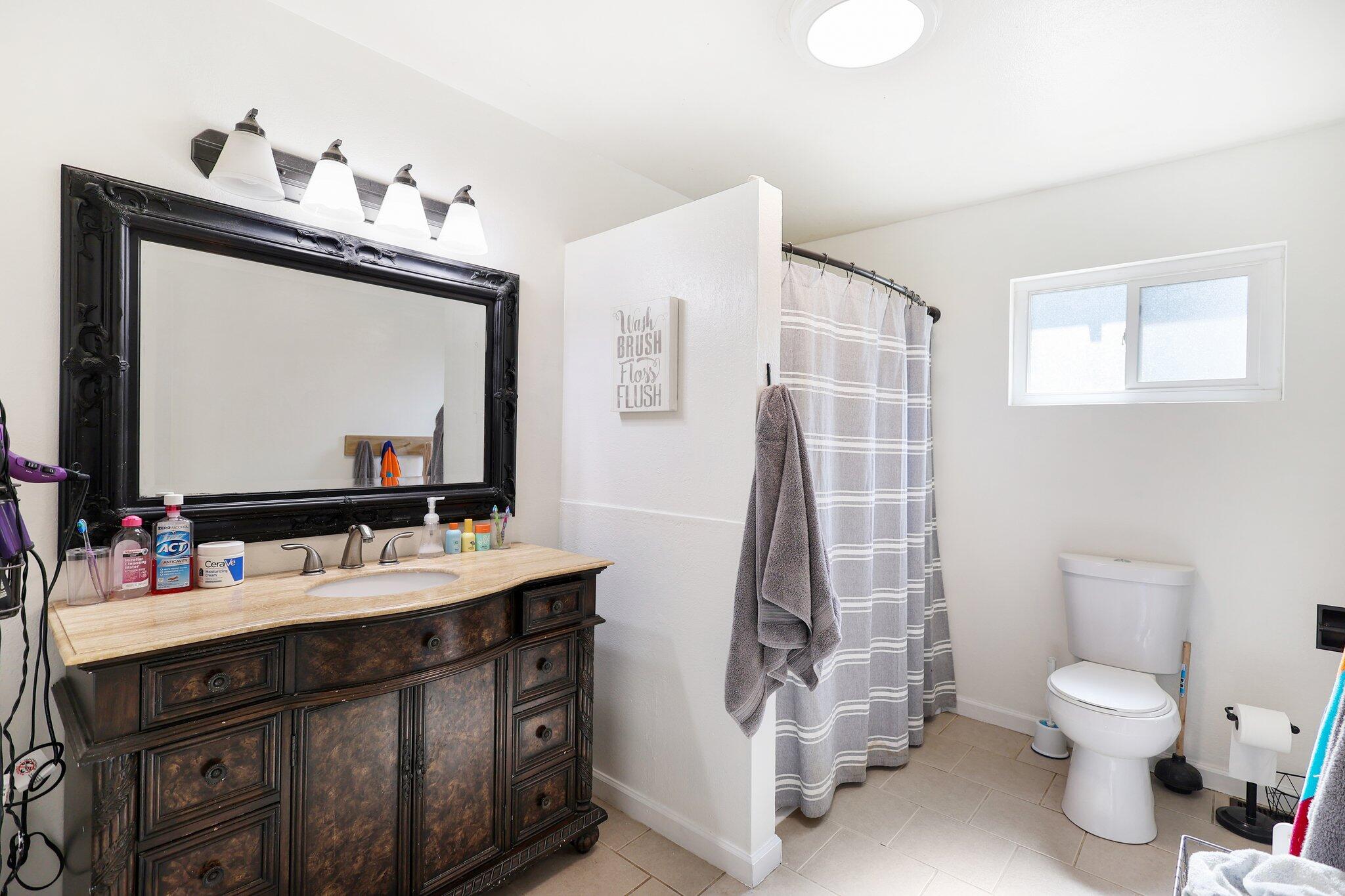 140 Chestnut Avenue Red Bluff, CA 96080 - Photo 13 of 26 a bathroom with a sink vanity mirror and toilet