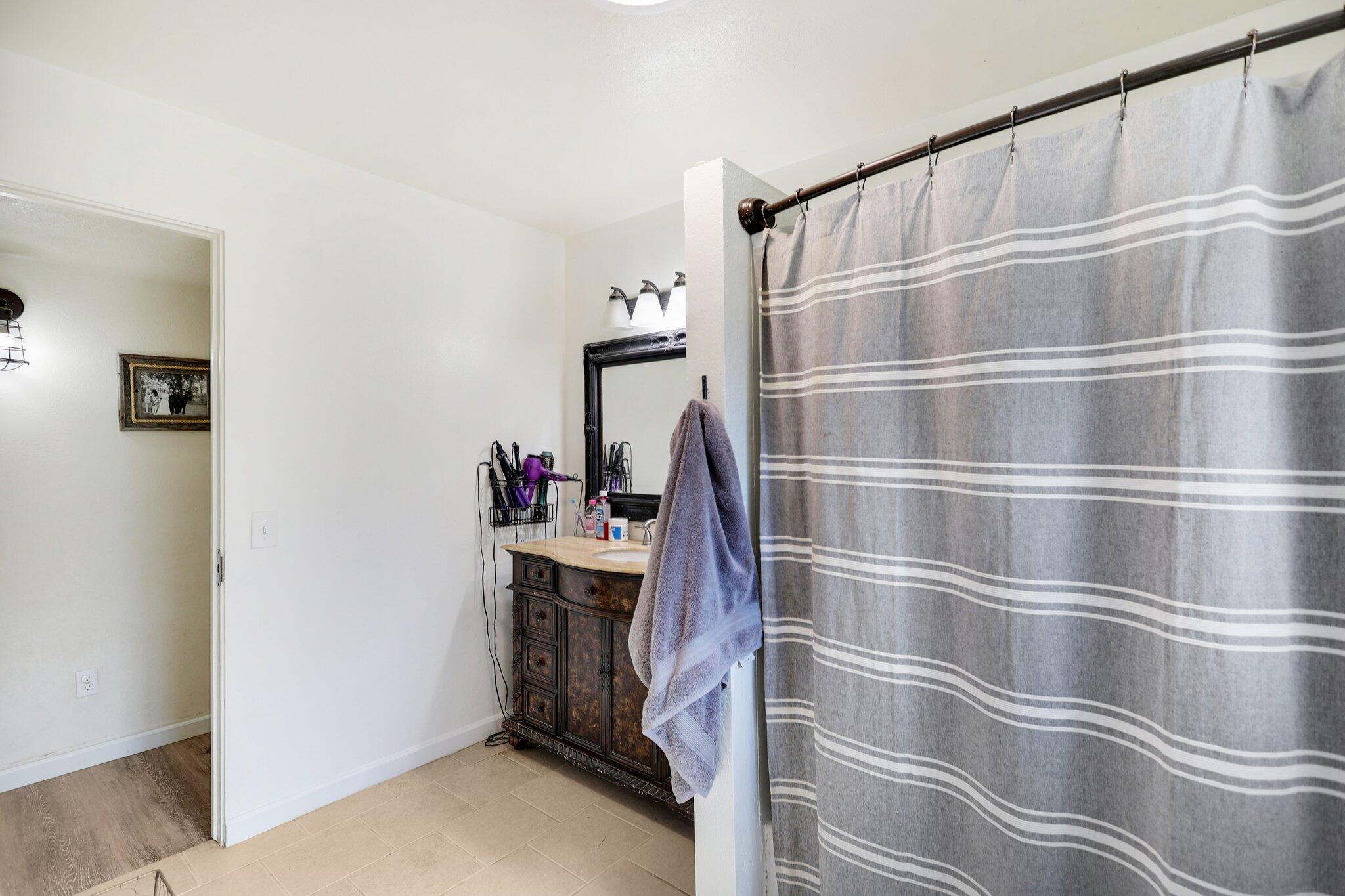140 Chestnut Avenue Red Bluff, CA 96080 - Photo 14 of 26 a bathroom with a bathtub and a shower